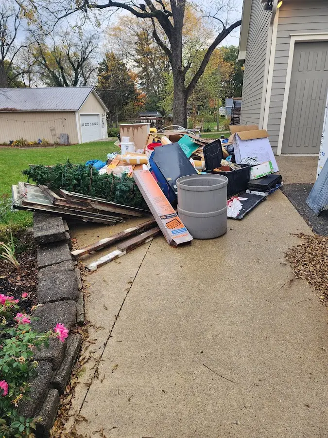 Dumpster being loaded with debris for 12 Yard Dumpster Rental in Indian Head